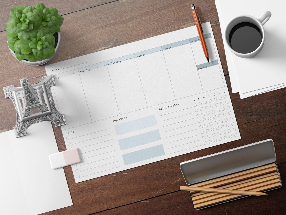 Organized desk with habit tracker notebook and planning materials